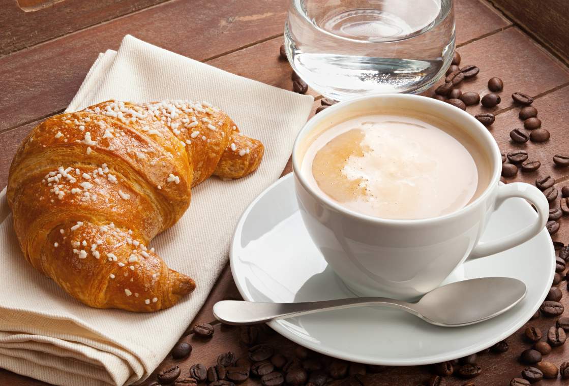 Coffee and croissant on a table